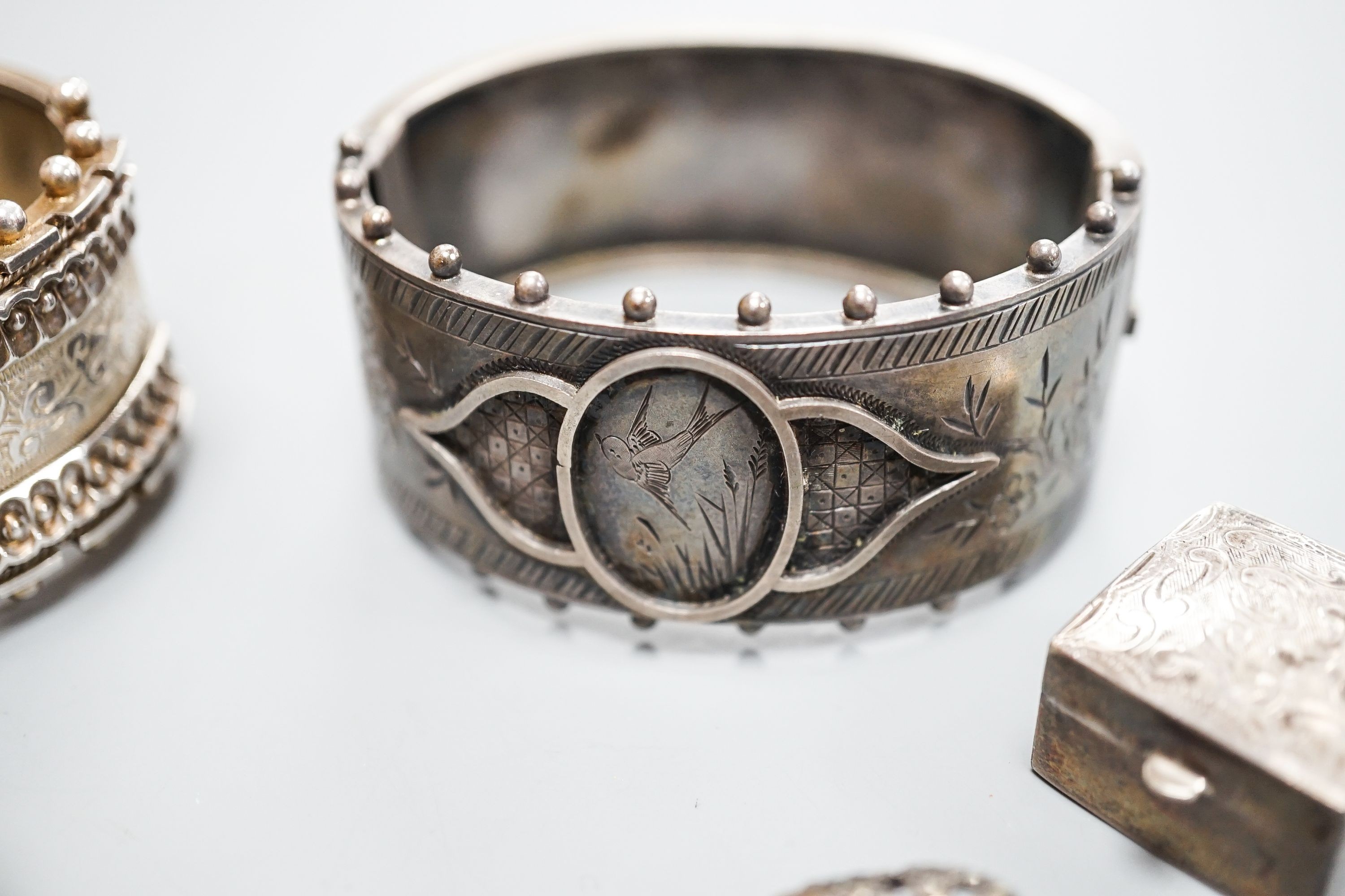 Two white metal bangles including sterling, a marcasite brooch, gem set yellow metal ring and other minor items.